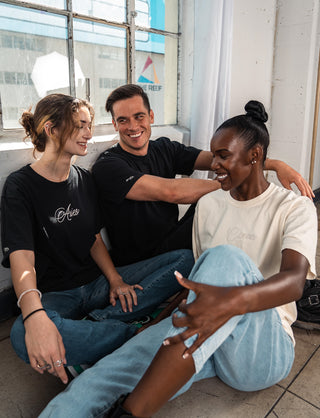 Group photo of models wearing oversized unisex tees with their zodiac sign