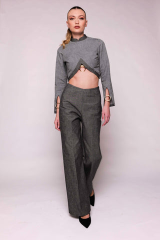 Model wearing a gray outfit on a white backdrop