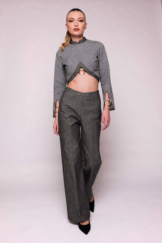 Model wearing a gray outfit on a white backdrop