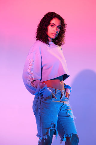 Light purple cropped sweatshirt featuring Sagittarius zodiac sign details.