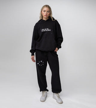 black hoodie with white constellation and text that reads "I will see you in a better world" on front of hoodie, part of loungewear set