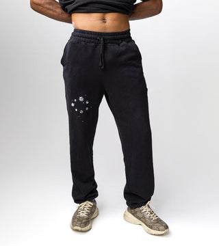 black sweatpants with high waisted band, spacious pockets, and galaxy design in white