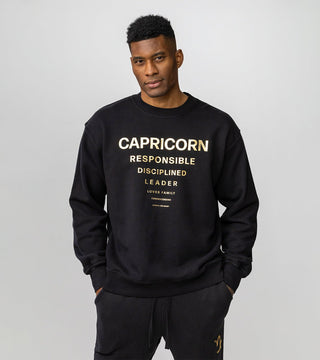 Capricorn inspired black crewneck with gold reflective foil reading "Capricorn" and personality traits