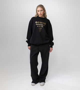 black crewneck with "Gemini" in gold foil and list of Gemini personality traits