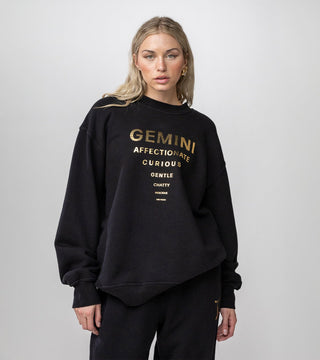 Gemini inspired black crewneck with "Gemini" in gold reflective foil and list of personality traits