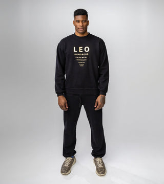 black crewneck with gold reflective foil reading "Leo" and Leo personality traits